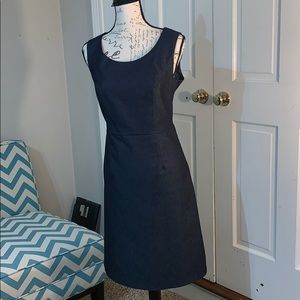 Sleeveless denim dress w/ side zipper. Below knee.
